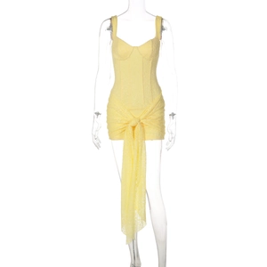 Dettaglio dell'abito in pizzo giallo con corpetto a corsetto e laccio in vita