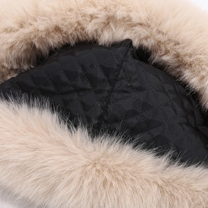 Detail of soft faux rabbit fur trim and black quilted inner lining for winter hat