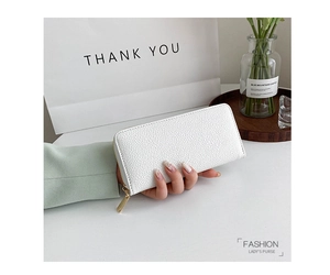 Detailed view of white lychee grain long wallet with gold zipper held by a model