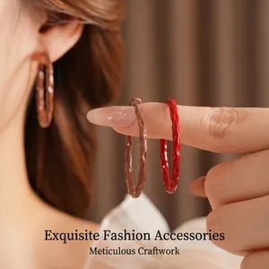 Vintage hammered hoop earrings in deep brown and red with textured metal finish