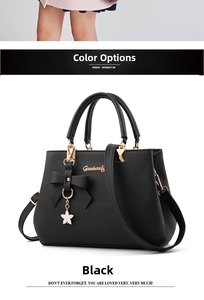 Detail of black bow-knot handbag with star charm and premium litchi leather texture
