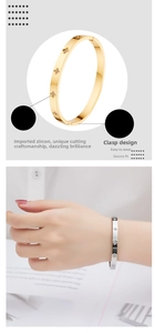 Detail of four-leaf clover bangle in gold and silver with zircon stones and clasp