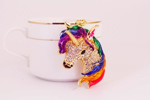 Detail of unicorn keychain with sparkling rhinestones and colorful enamel mane accents