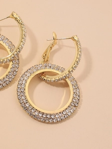 Detailed view of double layered gold hoop earrings with sparkling micro pave zircons