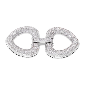 Macro detail of silver interlocking heart connectors with clear zircon pavé for jewelry
