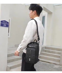 Detail of multi-compartment black waterproof sling bag with professional lettering