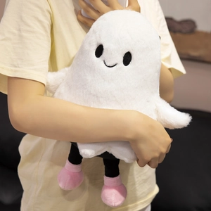 Close-up of white plush ghost doll with pink shoes held to show material and size