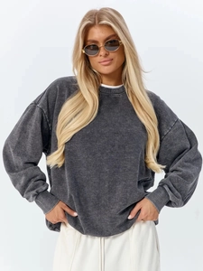Detail of crewneck sweatshirt showing vintage washed texture and ribbed cotton cuffs