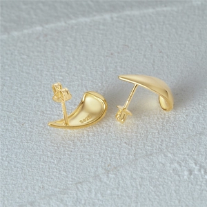 Macro view of C-shaped star stud earrings in polished gold plated S925 silver