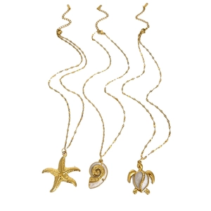 Gold ocean necklaces set with starfish turtle and conch shell enamel pendants
