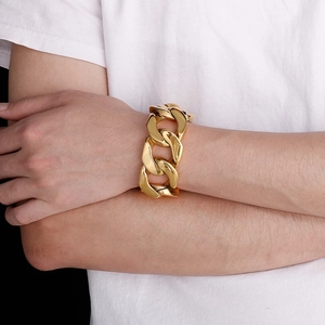 Men's bold gold-plated stainless steel Cuban link bracelet shown worn on a wrist