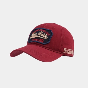 Detailed close-up of wine red baseball cap with vintage New York denim embroidery