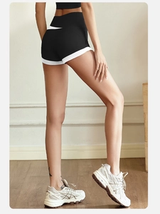 Macro detail of high-waisted peach lift sports shorts with contrast white piping