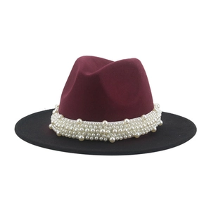 Detail of wool fedora with burgundy crown, black brim and decorative white pearl band