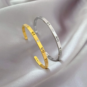 Gold and silver stainless steel open bangles with Roman numerals and cubic zirconia
