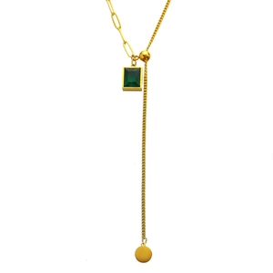 Golden Y-shaped necklace featuring a square green zircon pendant and minimalist metal disc