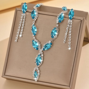 Detail of silver bridal jewelry set with sky blue marquise gems and tassel earrings