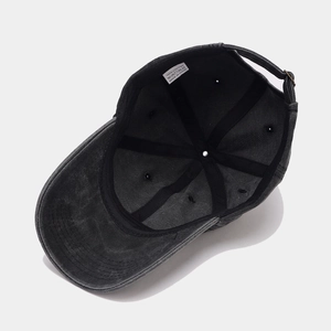 Detail view of washed cotton baseball cap interior with 100% cotton label and metal buckle