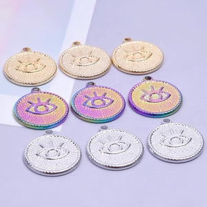 Detail of Devil's Eye round pendants in gold, silver and colorful stainless steel finish