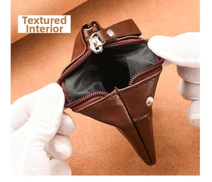 Detailed view of the dark brown leather wallet interior with textured lining and sturdy zipper
