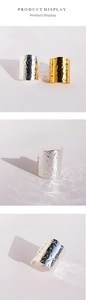 Close-up of lava texture on wide open rings in gold and silver metal finishes