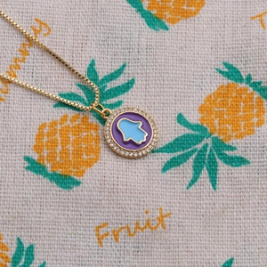 Gold Hamsa Hand pendant necklace with purple enamel and clear zircon stones for women