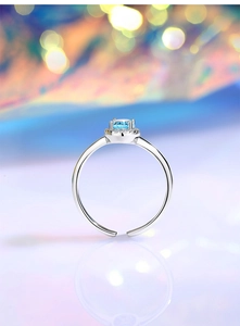 Macro shot of S925 silver ring featuring a large blue aquamarine and shimmering diamonds