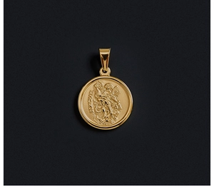 Macro shot of 18K gold plated St. Michael coin pendant with detailed religious engraving