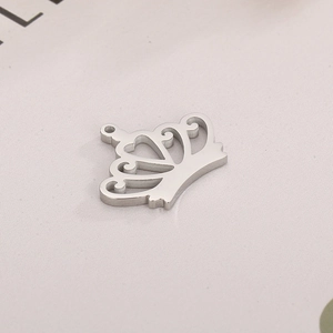 Close-up of a silver hollow crown pendant with heart-shaped metal craft details