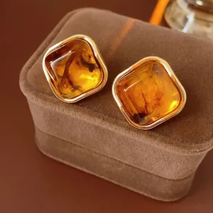 Vintage geometric amber brown square earrings with gold frame on jewelry box