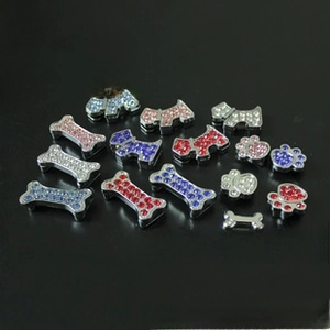 Macro detail of rhinestone dog charms in bone, terrier, and paw shapes for DIY keychains