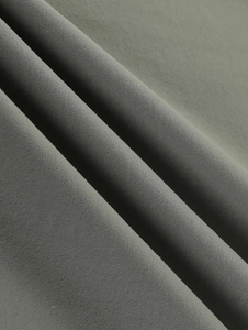Macro detail of olive green high-elasticity fabric showing fine twill texture and softness