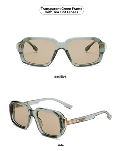 Detail of transparent green aviator frames with amber lenses and gold metal hinges