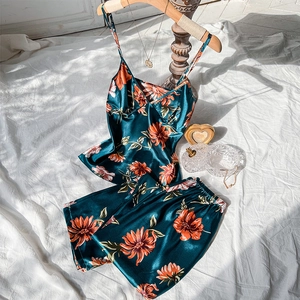 Green silk camisole pajama set with orange floral print and matching shorts in silk finish
