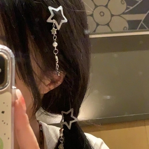 Silver star hair clip with dangling tassel chains shown in a mirror selfie style
