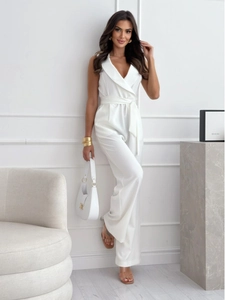Detail of white sleeveless jumpsuit featuring V-neck lapel and waist tie belt