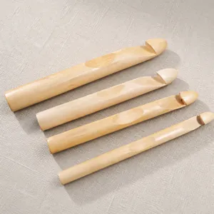 Detailed set of four polished bamboo dreadlock crochet needles in varying diameters