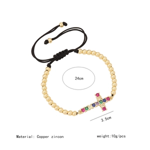 Detail view of colorful zircon cross bracelet with adjustable cord and copper beads