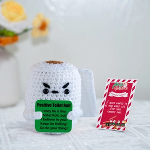 Macro shot of crochet positive toilet roll doll with emotional support message card