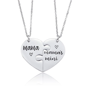 Macro view of mother and daughter puzzle heart necklaces with mama mini engraving