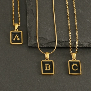 Detail of 18K gold letter pendants A B C with box snake and cross chain styles