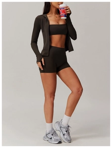 Close-up of deep brown three-piece yoga set with zippered jacket and high waist shorts