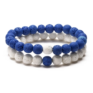 Detail shot of blue and white volcanic lava stone couple bracelets with porous texture