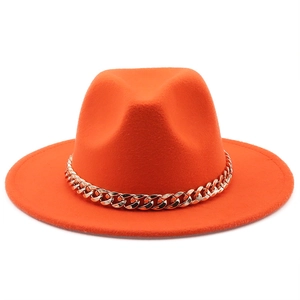 Detail view of bright orange wool felt jazz hat featuring a decorative gold chain link