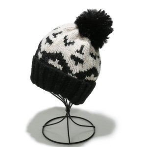 Winter mohair knit beanie with geometric bat patterns and a fluffy black pom-pom top