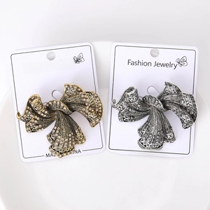 Detailed view of vintage bow brooches with intricate filigree and crystal inlay craft