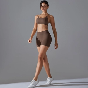 Close-up of deep brown seamless sports bra and high-waist peach lift yoga shorts
