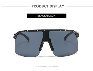 Front view of black cycling sunglasses with white splatter dots and dark grey lenses