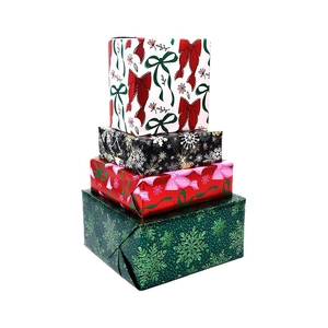 Set of four Christmas gift boxes with red and green snowflake patterns and pink bows