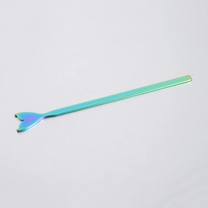 Macro shot of iridescent rainbow stainless steel mermaid tail stirrer with polished finish